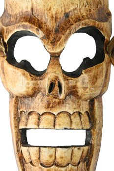 Handmade wooden carved creepy skull death joker mask on white background