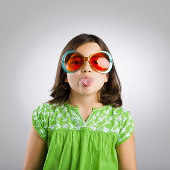 Portrait of a happy young girl wearing funny sunglasses