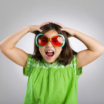 Portrait of a happy young girl wearing funny sunglasses