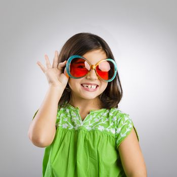 Portrait of a happy young girl wearing funny sunglasses