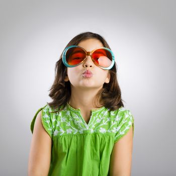 Portrait of a happy young girl wearing funny sunglasses