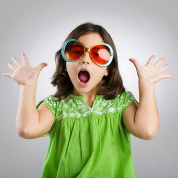 Portrait of a happy young girl wearing funny sunglasses