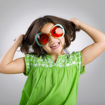 Portrait of a happy young girl wearing funny sunglasses