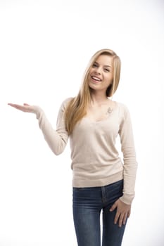 Beautiful and happy girl showing something, isolated over white background 