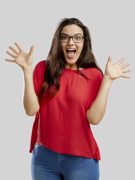 Happy woman with arms up, isolated over white background