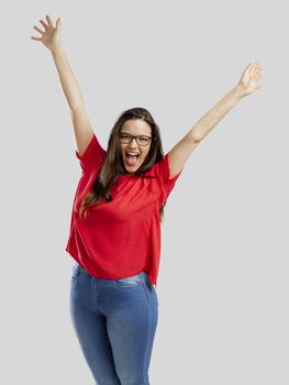 Happy woman with arms up, isolated over white background