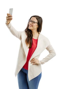 Beautiful woman making a  selfie with the phone, isolated over white background