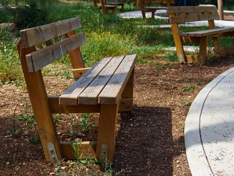 Modern design bench made of wood in a lovely city park