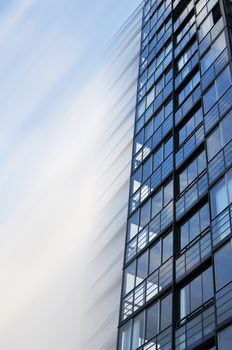 Highrise glass building in motion.