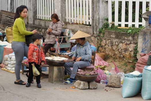 LUANG PRABANG, LAOS - FEBRUARY 13, 2016: People on the morning open air market of Luang Prabang on February 13, 2016 in Laos, Asia