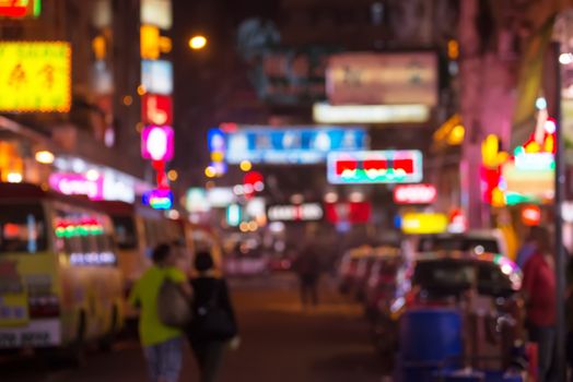blurred image of people moving in night city  Jordan neighborhood street. Art toning abstract urban background. Hong Kong