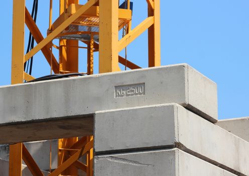 Construction crane with heavy contrablocks and blue sky