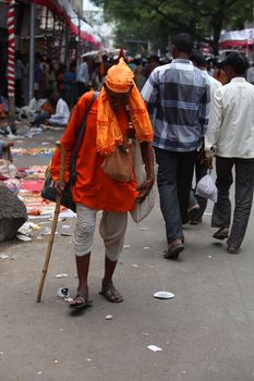 Pune, India - July 11, 2015: An old pilgrim known as warkari walking down the road during the famous Wari festival in India.