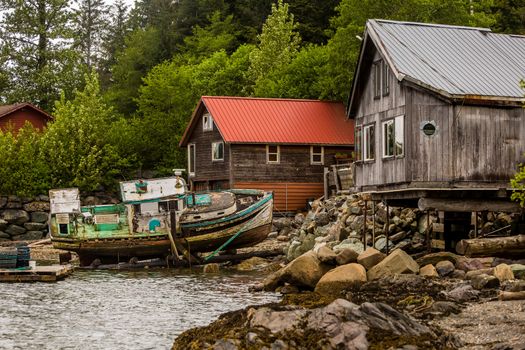 Waterfront buildings and an abandoned boat near Ketchikan in Alaska