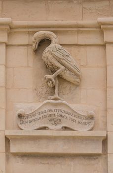 Detail of a fortification tower, city Senglea, island Malta, Gardjola Gardens. Motive of a crane bird.