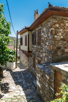 Landscape view of historical Doganbeyli village in Aydin, Turkey with historical small stone houses on bright blue sky background.