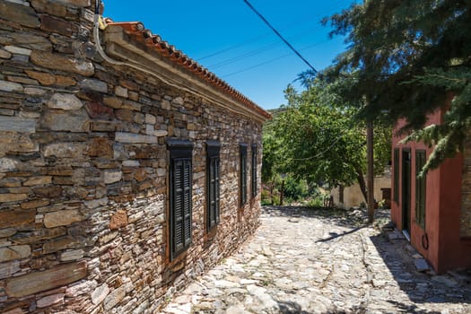 Landscape view of historical Doganbeyli village in Aydin, Turkey with historical small stone houses on bright blue sky background.