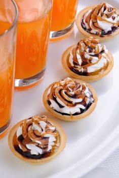 Shortbread сakes filled jam with whipped cream and chocolate, caramel topping