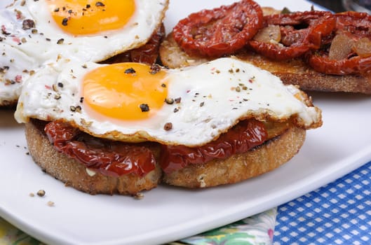 Sandwich with slices of dried tomatoes and egg flavored spices closeup