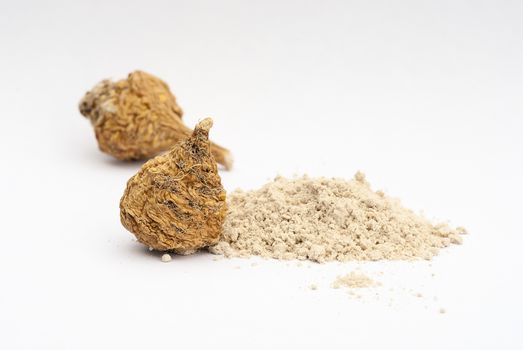 Peruvian ginseng or maca (Lepidium meyenii), dried root and  powder on wooden table