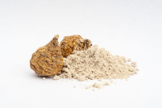 Peruvian ginseng or maca (Lepidium meyenii), dried root and  powder on wooden table