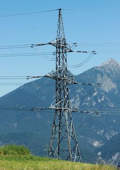 Pylon on mountain top with blue sky