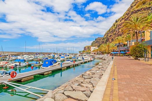 Calheta, Madeira - June 8, 2013: Promenade of the town Calheta in the west of Madeira. On the left the new marina of the town.