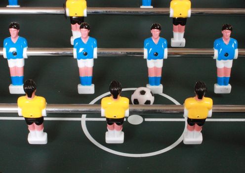 Football table game with blue and yellow players