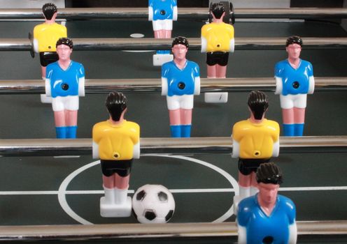 Football table game with blue and yellow players