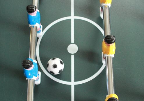 Football table game with blue and yellow players