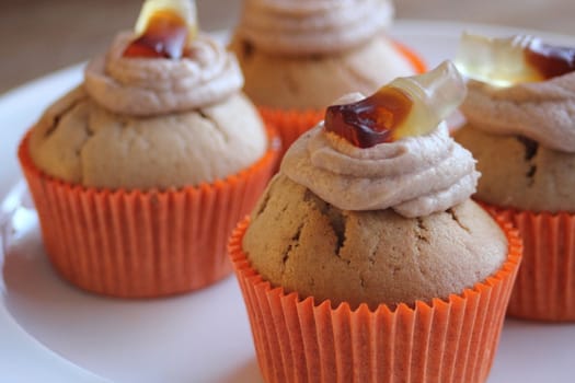 Cola cupcakes with orange mould and winegum on top