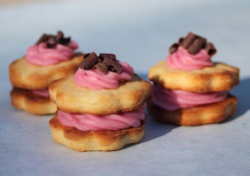 Blueberry medallions with frosting and chocolate on top