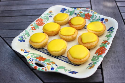 Lemon cupcakes with yellow glaze on top