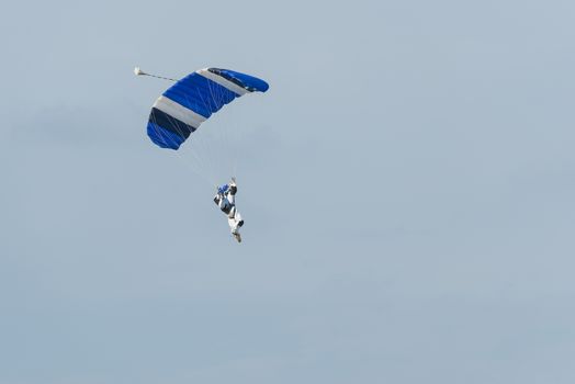 Parachutist floating to a square-shaped parachute
