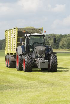 transport of cut grass with tractor and loader wagon