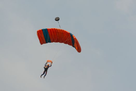 Parachutist floating to a square-shaped parachute
