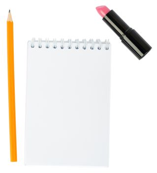 Open copybook with lipstick on isolated white background