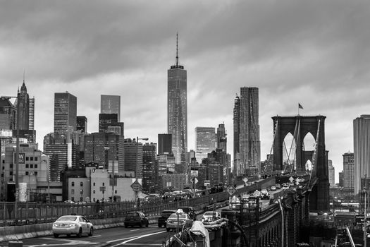 New York City, United States of America - March 25: Traffic on Brooklyn bridge and New York City Manhattan downtown skyline at dusk with skyscrapers over East River panorama on March 25, 2015.