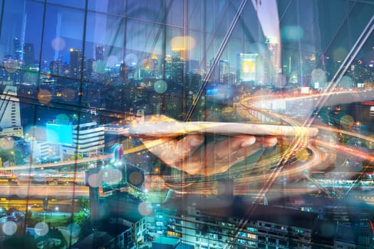 Double Exposure of BusinessMan hold Digital Tablet with Modern City Building and Highway as Digital Technology concept