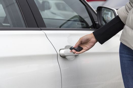 the hand of the girl keeps the handle door white passenger car