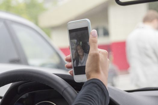 the girl behind the wheel of a car photographed themselves on mobile phone