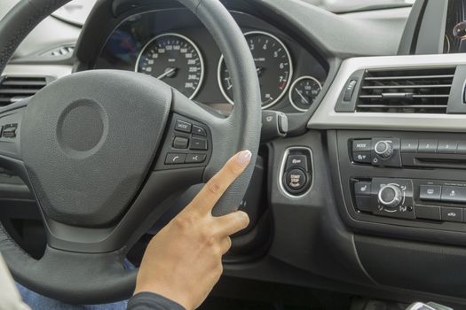 the girl with the manicure keeps hands on the steering wheel of the car