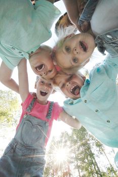 Group of smiling children looking down into camera