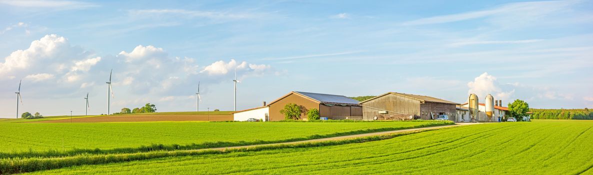 Bartholomae, Germany - May 26, 2016: Farm panorama surrounded by green fields / meadow, blue sky