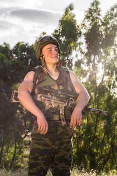 young a soldier in the uniform with weapon