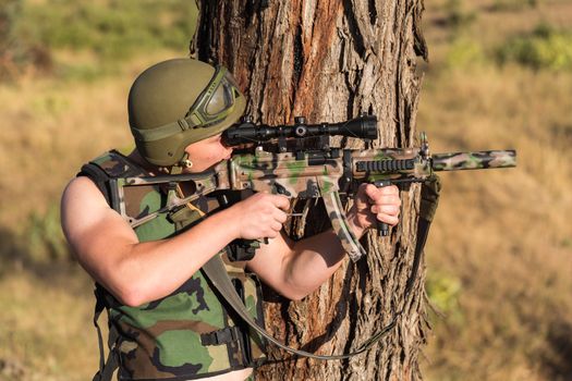 young a soldier in the uniform with weapon