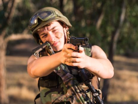 young a soldier in the uniform with weapon