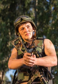 young a soldier in the uniform with weapon