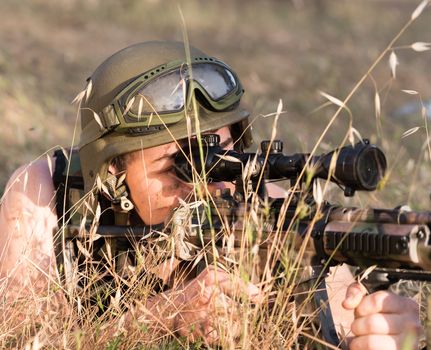 young a soldier in the uniform with weapon