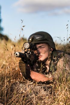 young a soldier in the uniform with weapon